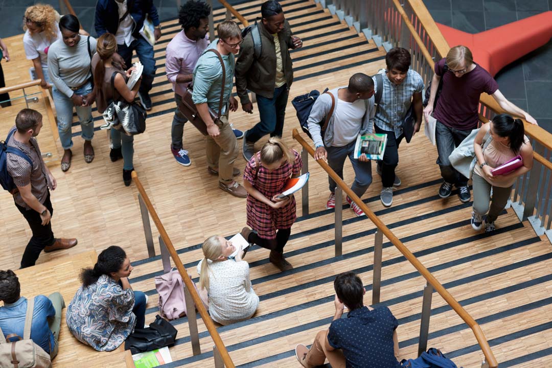 Elevated view of university students walking up and down stairs