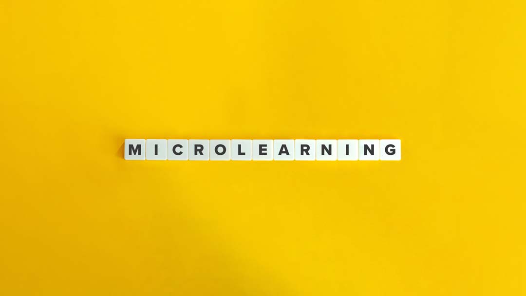 Yellow background and tiles that spell microlearning