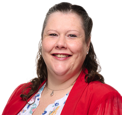 TJ Editor Jo Cook smiling, wearing a red jacket