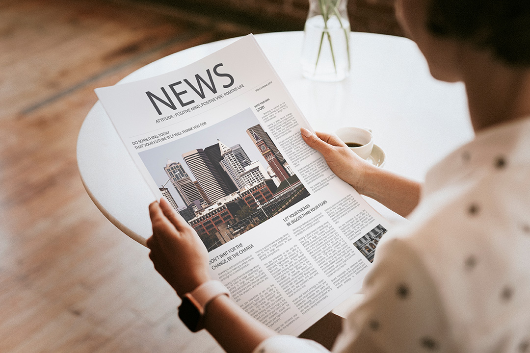 Woman holding a newspaper