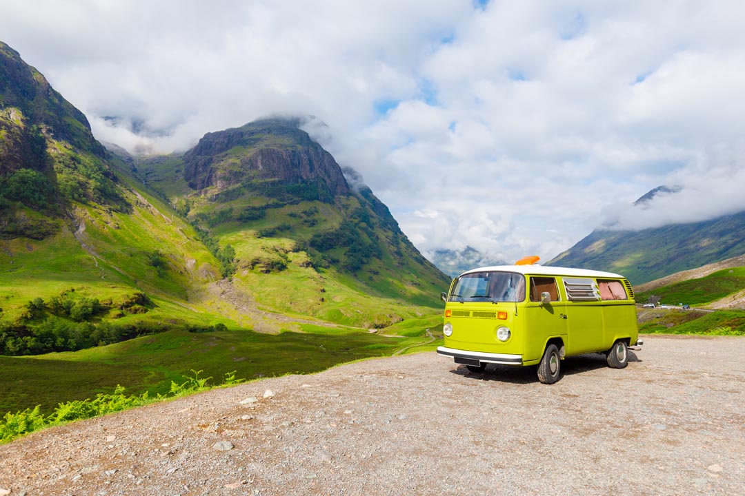 Lime green Volks Wagon old type two camper van at three sister near Glencoe in Scotland - mountain backgrounds stunning scenary.