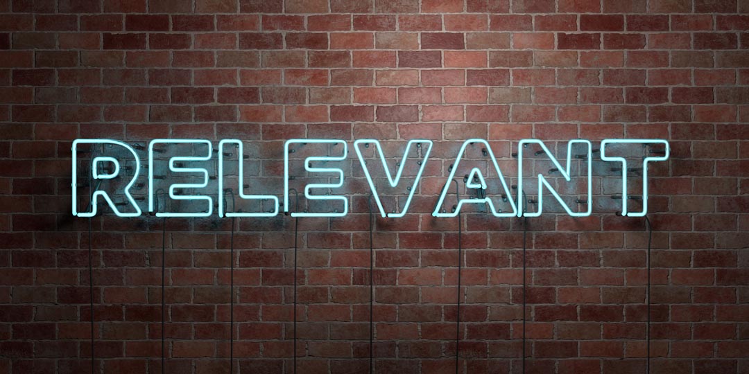 RELEVANT - fluorescent Neon tube Sign on brickwork