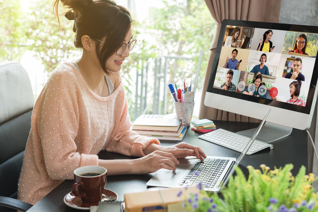 Asian woman work from home during using laptop for teleconference with her team
