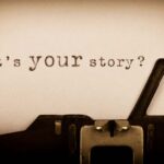 What's your story? written on paper from a typewriter that is just about in the picture.