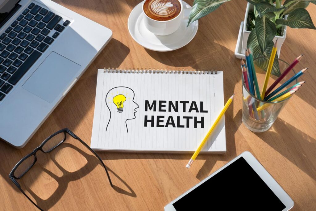 MENTAL HEALTH open book on table and coffee Business