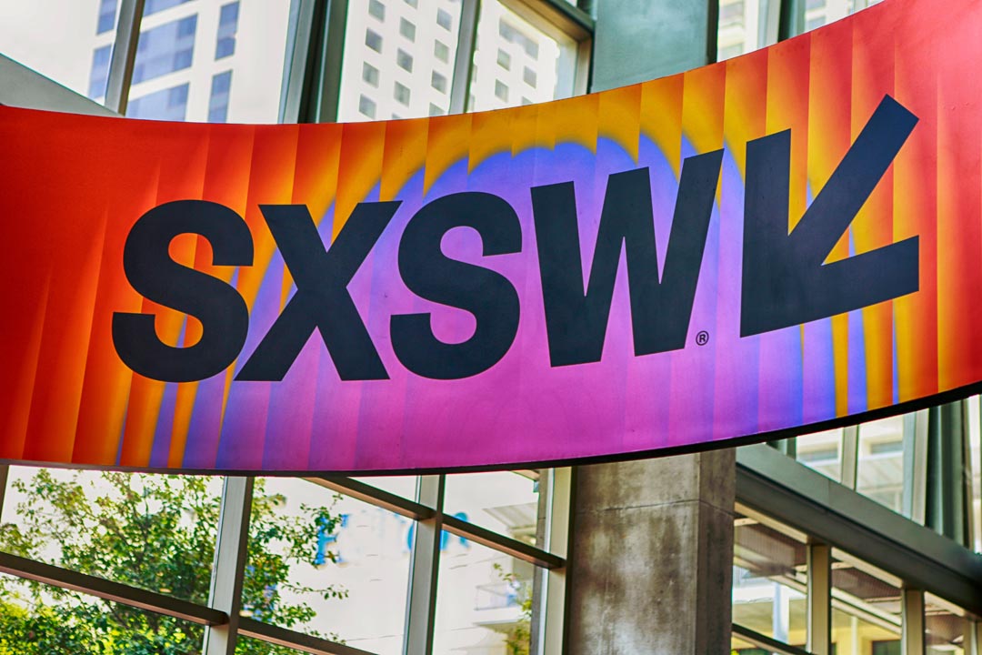 South by Southwest Annual meeting banner, showing SXSW with a building in the background.
