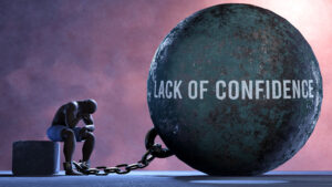 Lack of confidence - a metaphor showing human struggle with Lack of confidence. Resigned and exhausted person chained to Lack of confidence. Depressed by a continuous struggle,3d illustration
