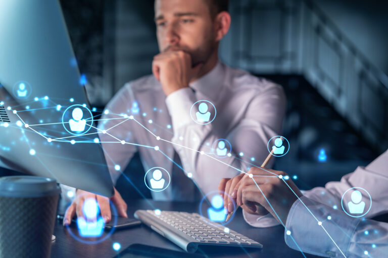 Businessman and businesswoman in formal wear working together looking for new employees to hire for international business consulting. HR, social media icons over modern panoramic office background