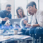 Concept of digital diagram,graph interfaces,virtual screen,connections icon on blurred background.Coworking team at business meeting.Group of colleagues working with startup project in modern office.