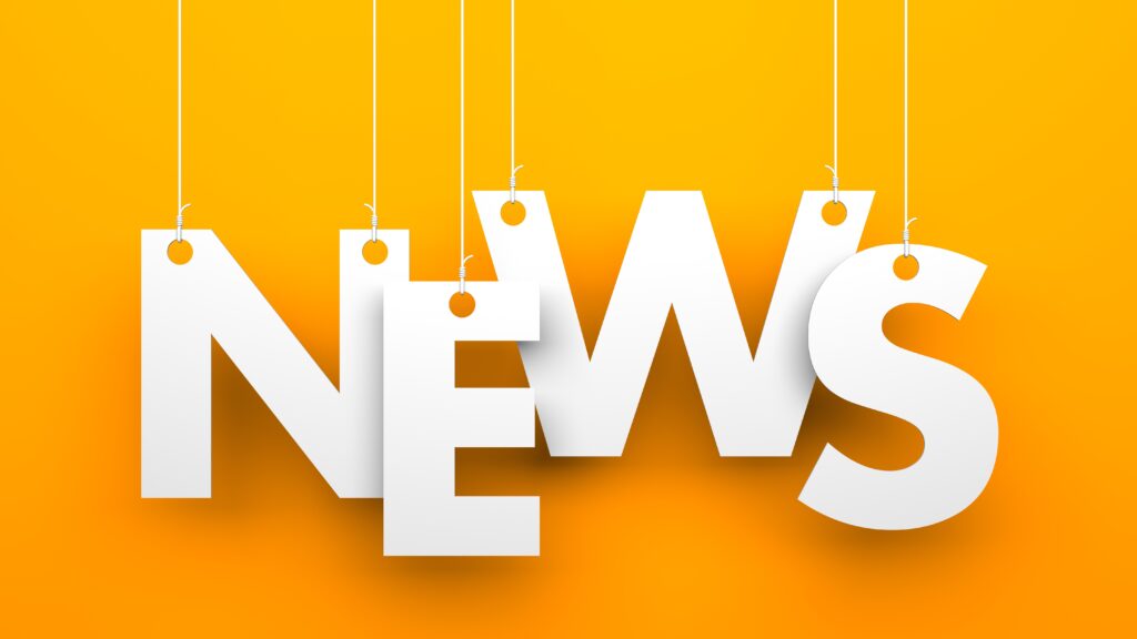 News - letters individually hanging down on threads with a yellow background.