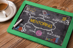 mentoring concept with business elements and related keywords on blackboard