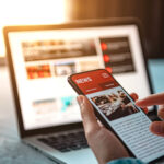 Online news on a smartphone. Mockup website. Woman reading news or articles in a mobile phone screen application at home. Newspaper and portal on internet.