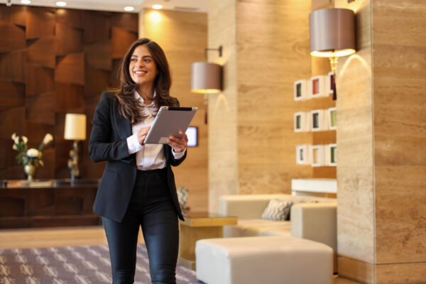 Young, ambitious businesswoman using tablet on the move