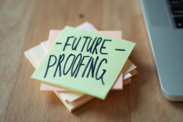 A vibrant stack of sticky notes sits on a wooden desk, with a bold Future Proofing note prominently displayed. This image captures the essence of planning and innovation, inspiring viewers to think