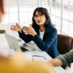 Professional woman talking to her team in an office meeting