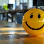 Yellow smiling ball in office promotes positive work environment and corporate culture. Concept Corporate Culture, Positive Work Environment, Office Decor, Yellow Smiling Ball, Promoting Happiness