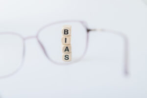 Cubes forming the word bias viewed through a lens