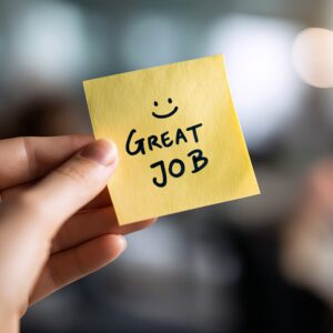 Positive Feedback Note Great Job Well Done Yellow Sticky Note Hand Holding Appreciation Encouragement Success Motivation Workplace Productivity Teamwork Excellent Performance Employee Recognition