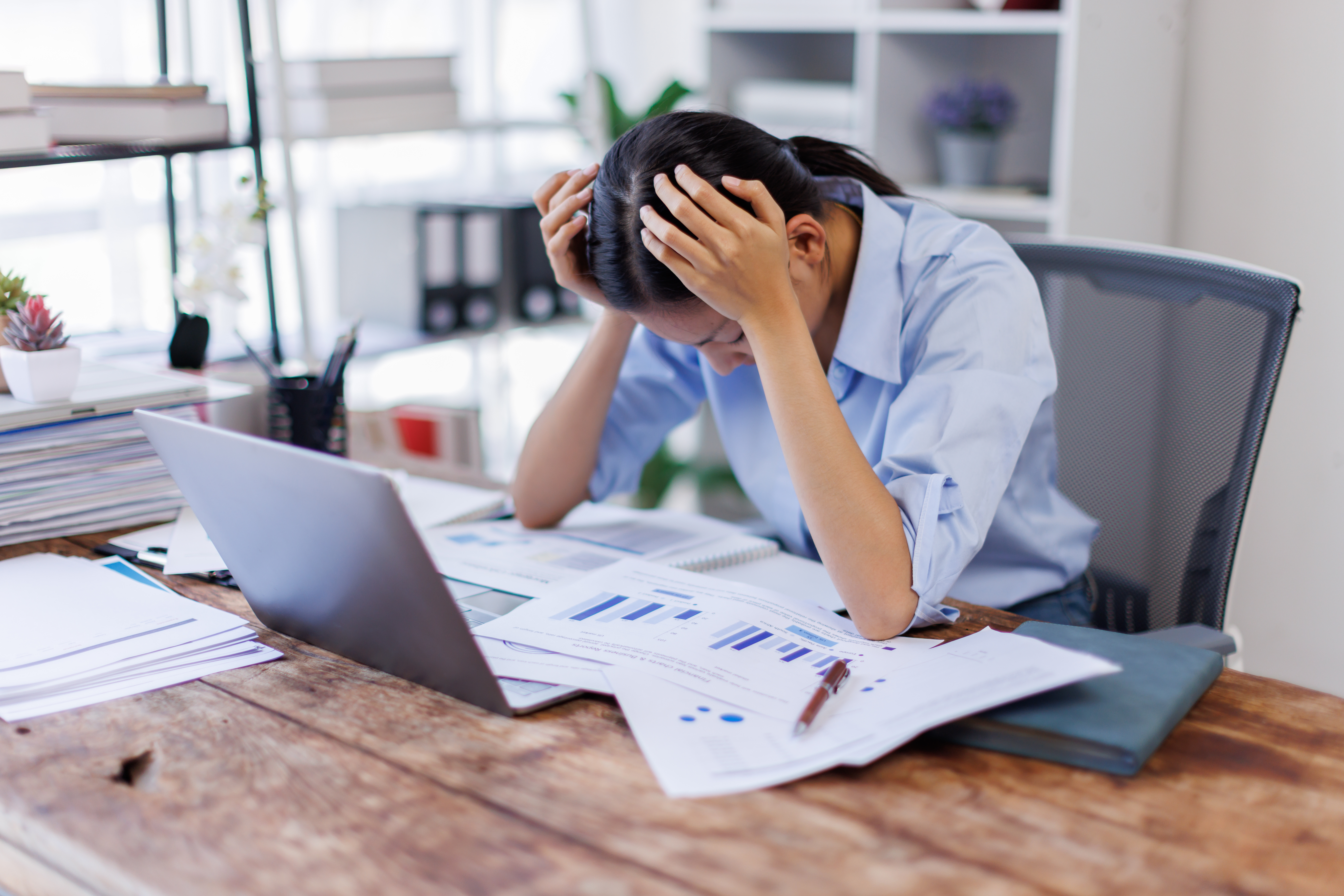 Stress, anxiety or headache of business asian woman working on laptop online report, proposal or copywriting at workplace office desk Burnout, frustrated corporate worker with problem, fail or error.