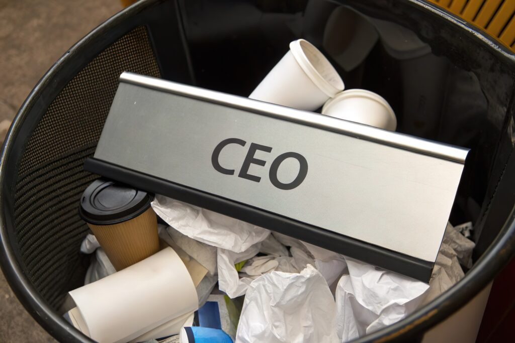CEO nameplate in trash bin. Leadership loss and resign