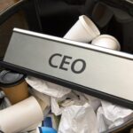 CEO nameplate in trash bin. Leadership loss and resign