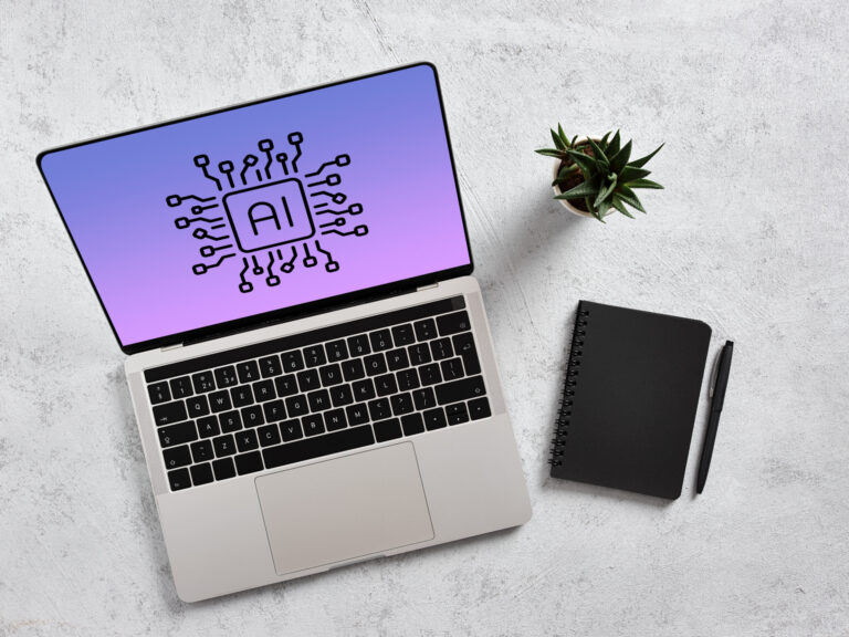 Laptop displaying artificial intelligence chipset on screen with notebook and pen on desk