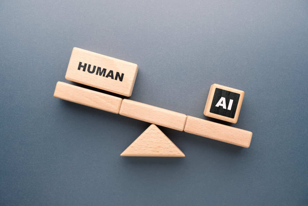 Wooden blocks on a seesaw showing human outweighing AI, symbolizing comparison between human capability and artificial intelligence in work and productivity
