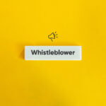 Whistleblower Protection Concept Image. Financial Crime and Fraud. Text on Block Letter Tile and Megaphone Icon on Yellow Background. Minimal Aesthetic.
