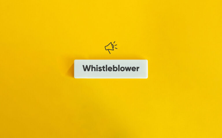 Whistleblower Protection Concept Image. Financial Crime and Fraud. Text on Block Letter Tile and Megaphone Icon on Yellow Background. Minimal Aesthetic.