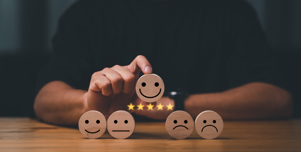 customer services best excellent business rating experience. Satisfaction survey concept. Hand of a businessman chooses a smile face on wood block circle. 5 Star Satisfaction.