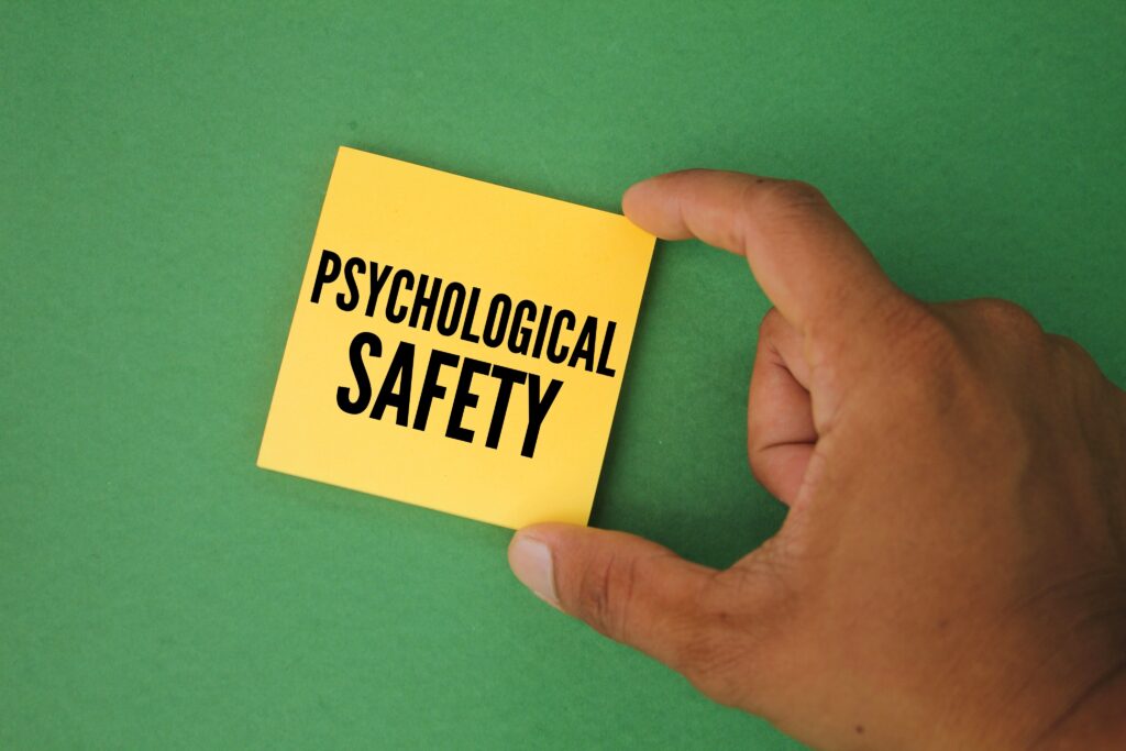 hand holding colored paper with the word psychological safety. the concept of therapy in occupational or psychological safety