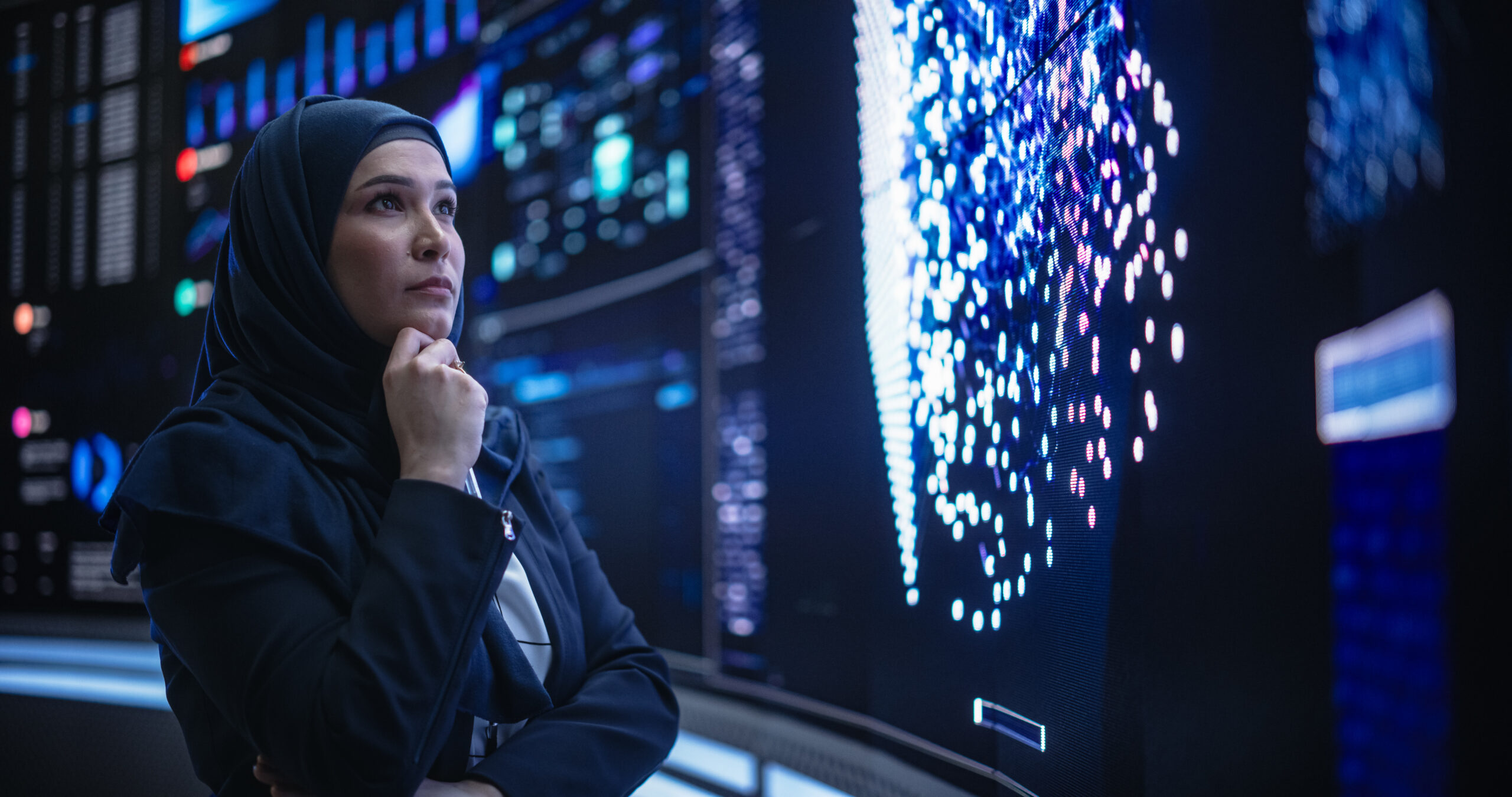 Portrait of a Thoughtful Middle Eastern Software Developer Working in Technological Corporate Office. Young Woman Testing Artificial Intelligence Algorithms for an Innovative Internet Project