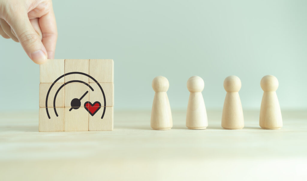 Soft skills and emotional intelligence in business leadership. Wooden blocks with heart and gauge icons, symbolizing soft skills, empathy, emotional intelligence and balanced business performance.