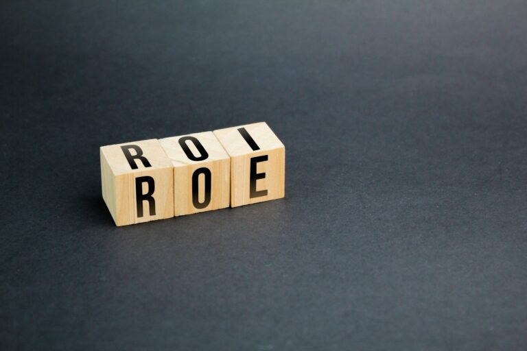 wooden cube with letters ROI and ROE. Return on Equity (ROE) vs. Return on Investment (ROI)