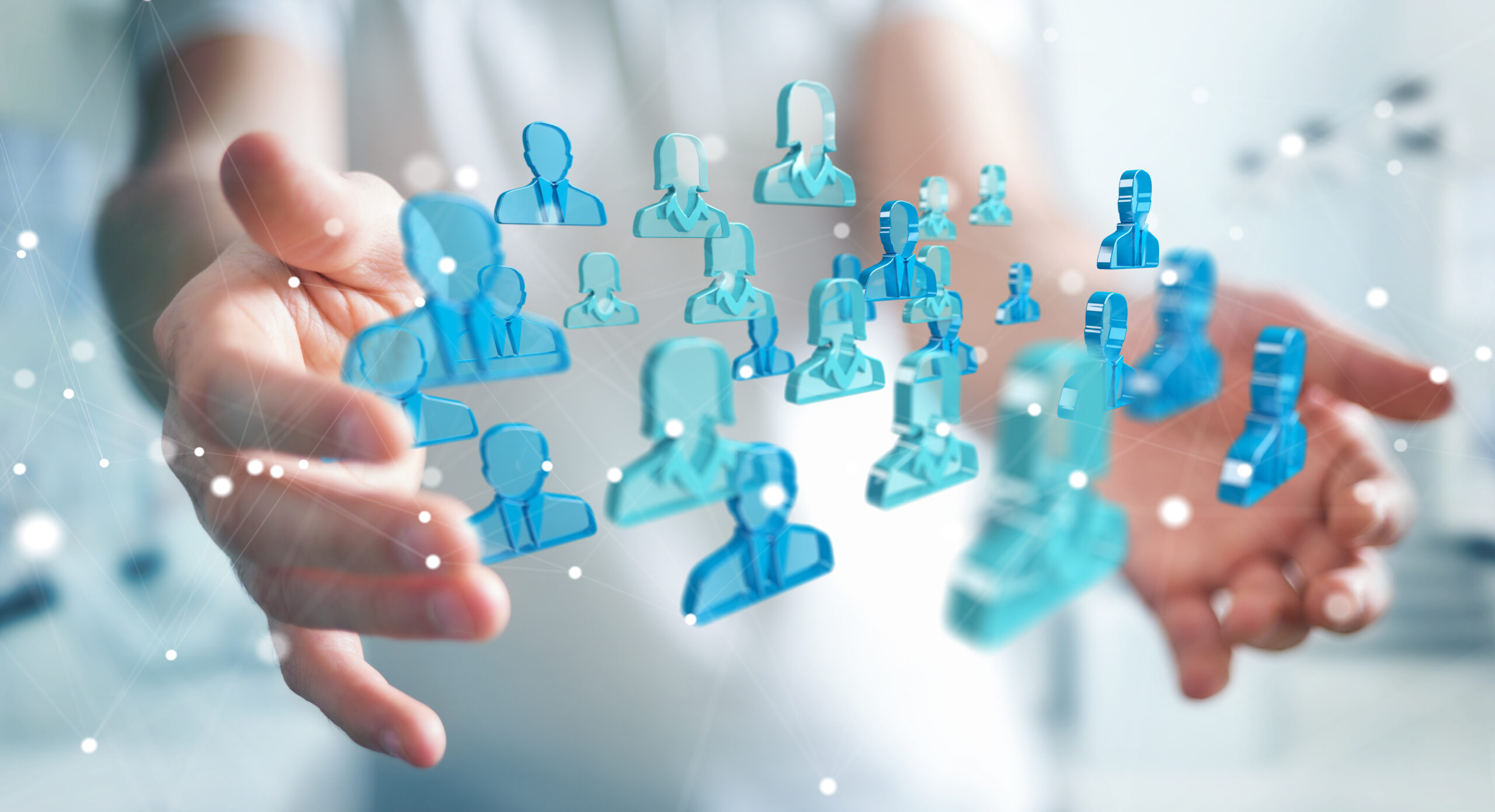 Businessman holding 3D rendering group of blue people