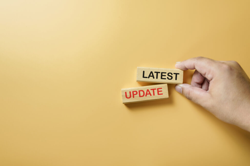 Hand holding wooden blocks with text "Latest Update", concept of news, announcement, information, communication, digital media, breaking news and technology trends.