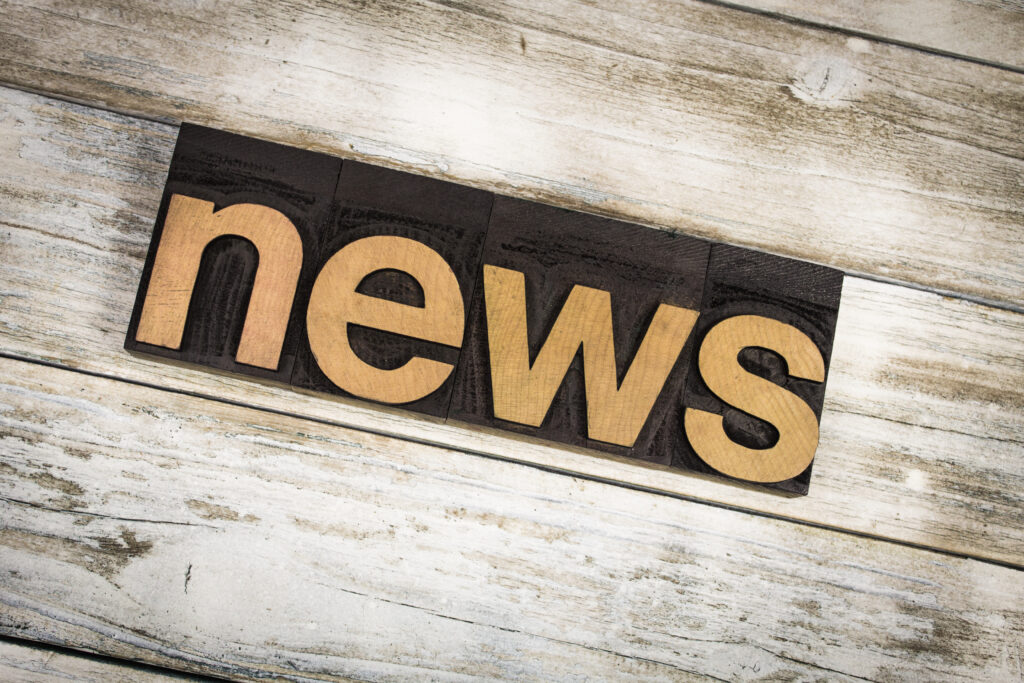 News Letterpress Word on Wooden Background