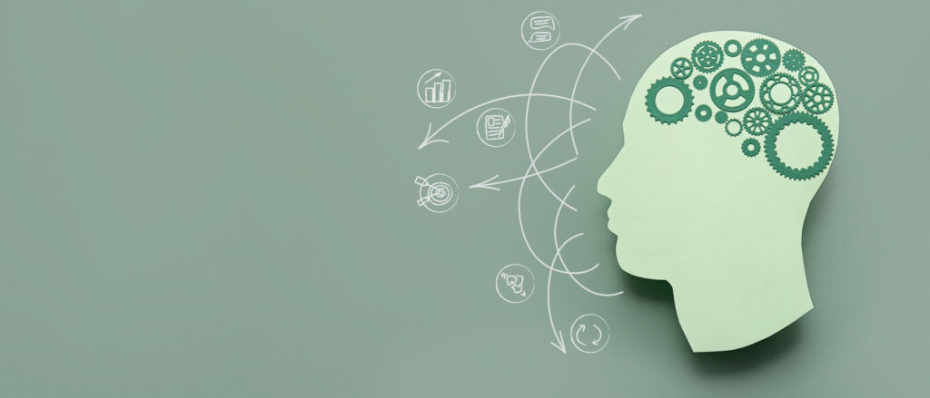 Paper human head with gears on green background with space for text. Concept of brainwork