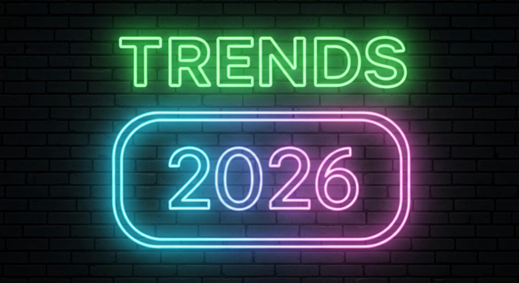 Glowing neon sign on brick wall displays Trends above 2026 within rounded rectangle, symbolizing future outlook, business, and forecasting year