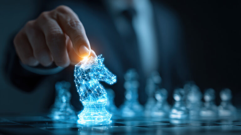 Close-up of businessman holding glowing blue digital chess knight hologram representing AI, strategy, innovation, and leadership.
