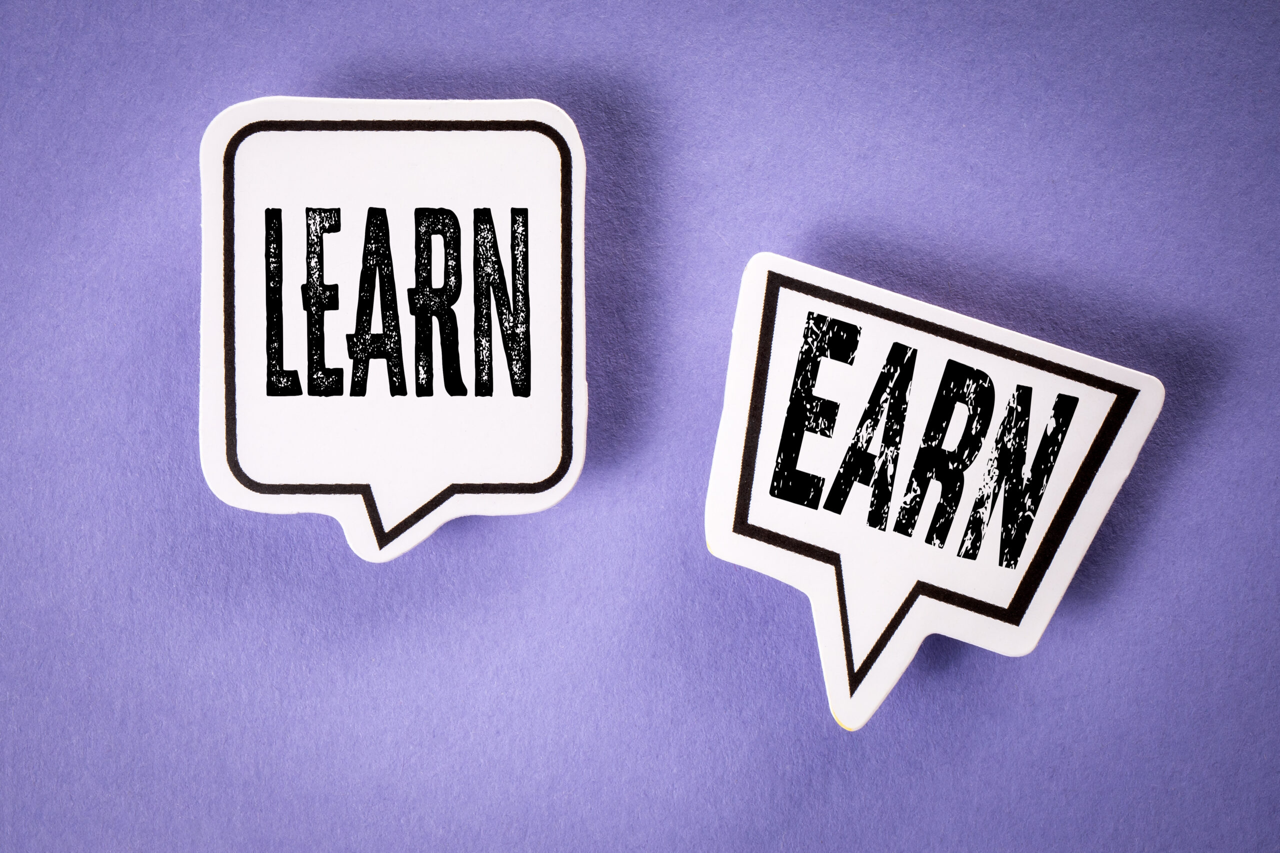 Learn and Earn Concept with Speech Bubbles on Purple Background