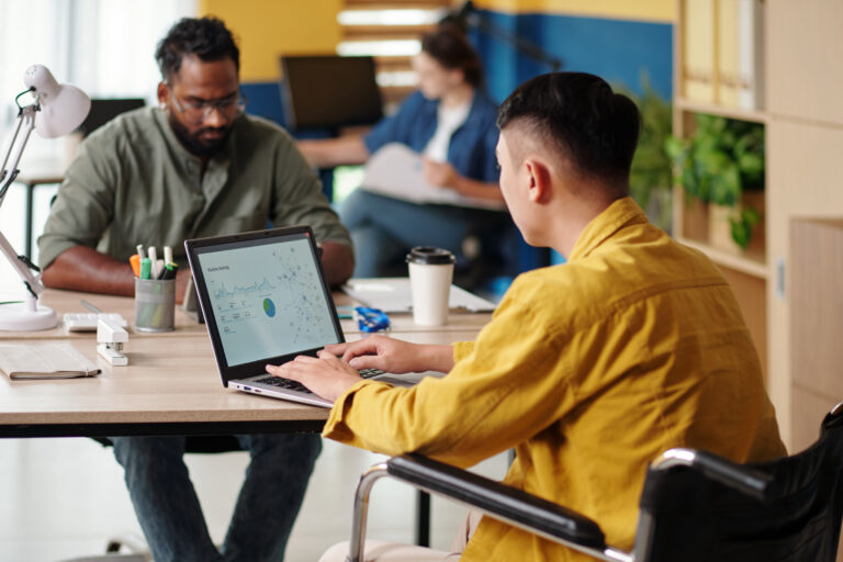 Manager working on laptop, creating report for meeting