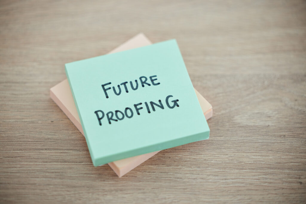 Sticky note, planning and schedule or desk text for writing or business growth ready for change. Post it or future proofing in leadership, creative innovation or new startup for company improvement
