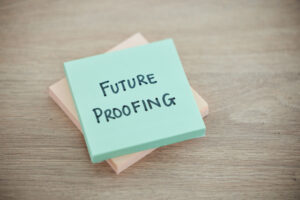 Sticky note, planning and schedule or desk text for writing or business growth ready for change. Post it or future proofing in leadership, creative innovation or new startup for company improvement