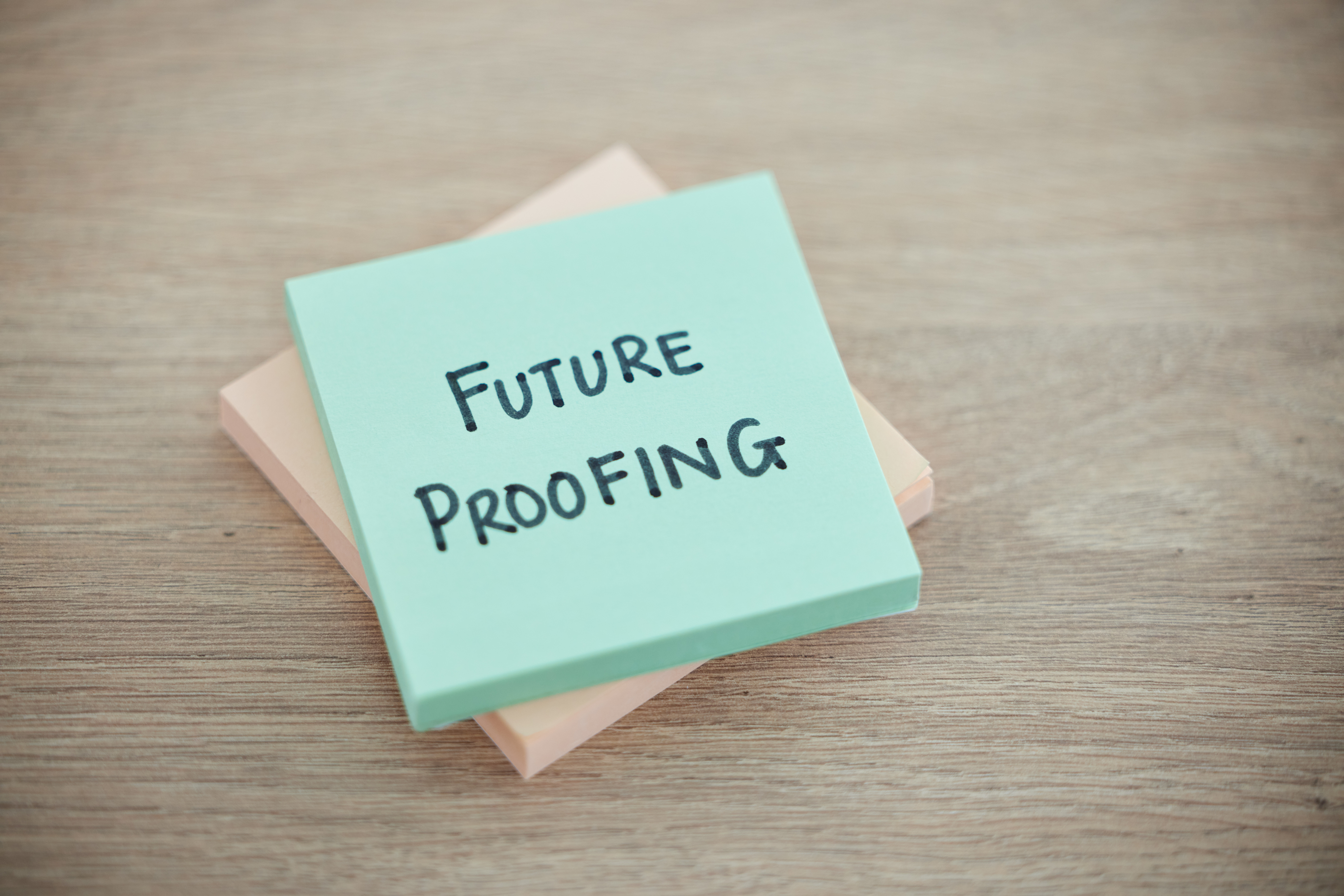 Sticky note, planning and schedule or desk text for writing or business growth ready for change. Post it or future proofing in leadership, creative innovation or new startup for company improvement