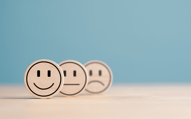 Wooden label with happy normal and sad face icons for experience survey services and products review concept. Customer or Client show Good Neutral or Negative feedback and satisfaction rating.