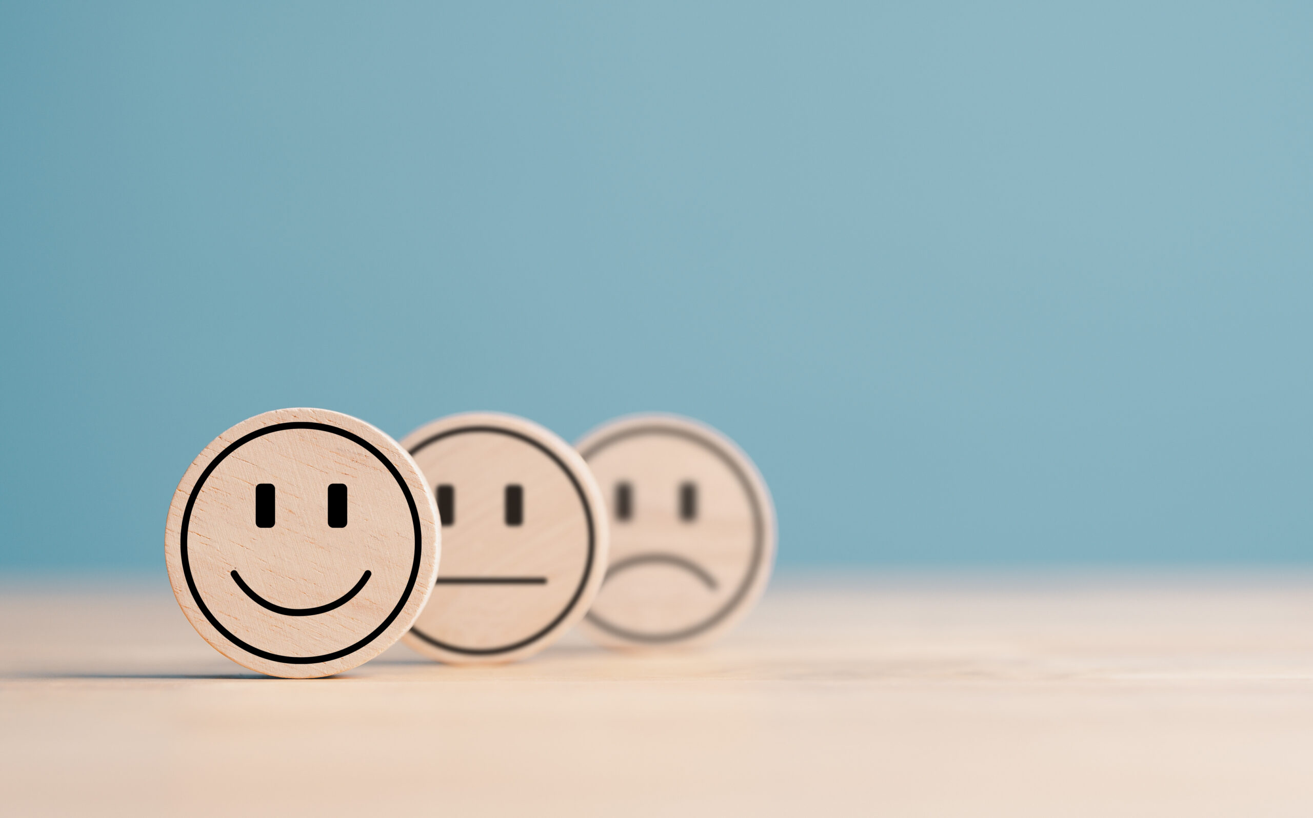 Wooden label with happy normal and sad face icons for experience survey services and products review concept. Customer or Client show Good Neutral or Negative feedback and satisfaction rating.