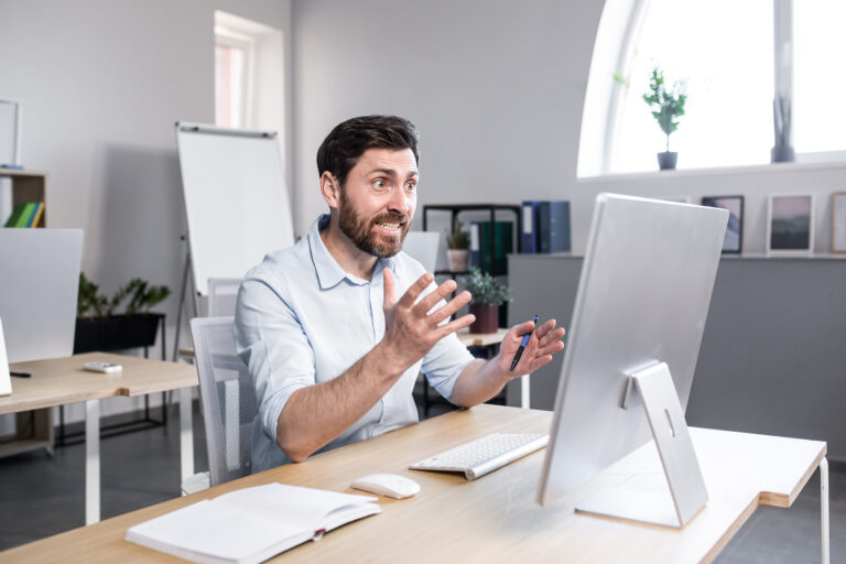 Sad and anxious man working in the office, businessman frustrated by the result of work tired and depressed looking at the monitor screen