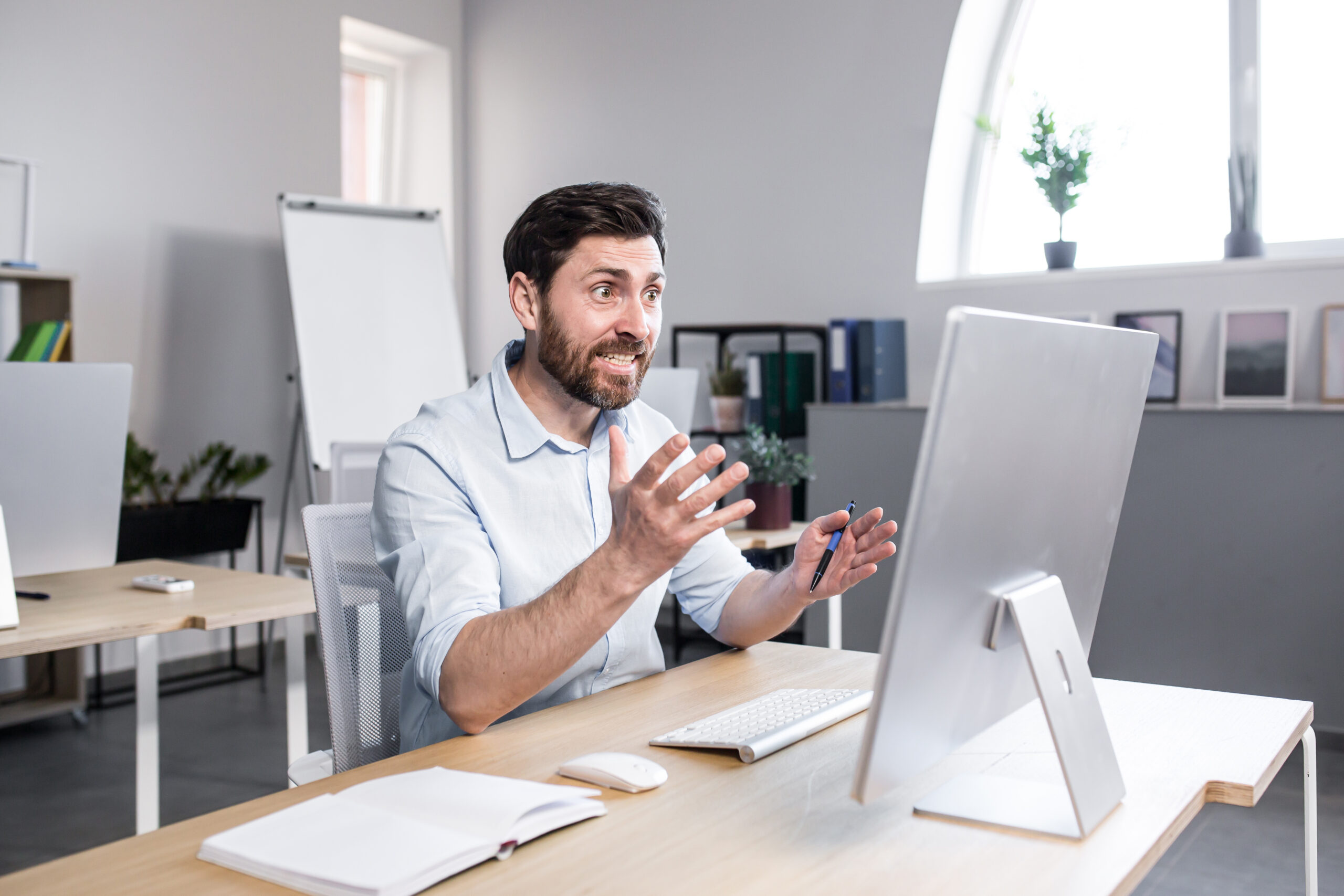 Sad and anxious man working in the office, businessman frustrated by the result of work tired and depressed looking at the monitor screen