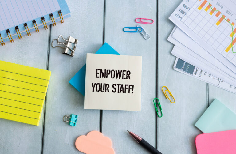 Wooden blocks with words 'Empower your staff'.